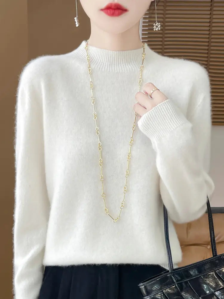 a soft off-white merino wool pullover sweater for women featuring a ribbed neckline and cuffs