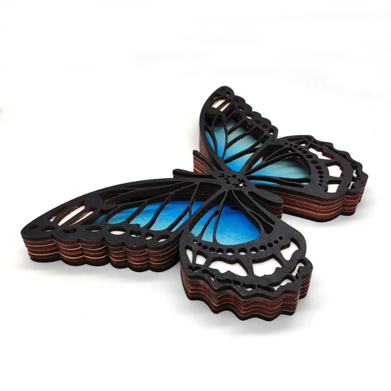 A layered wooden butterfly wall decoration with intricate cut-out patterns and a vibrant blue gradient fill for led light tabletop decor.