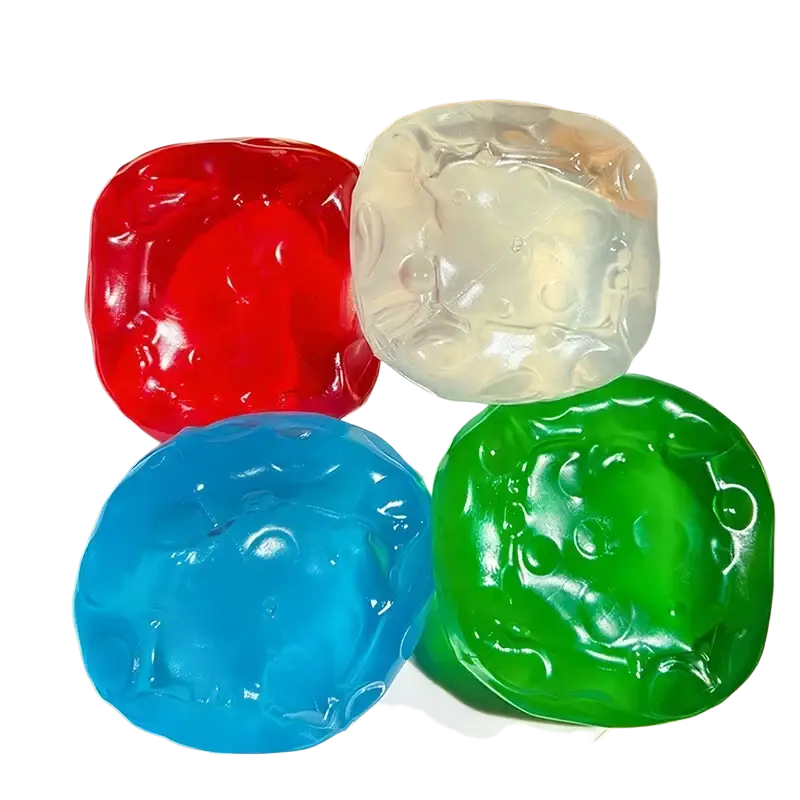 Four translucent bear-shaped colorful vaseline cheese squishy stress balls in red blue green and clear on white plate
