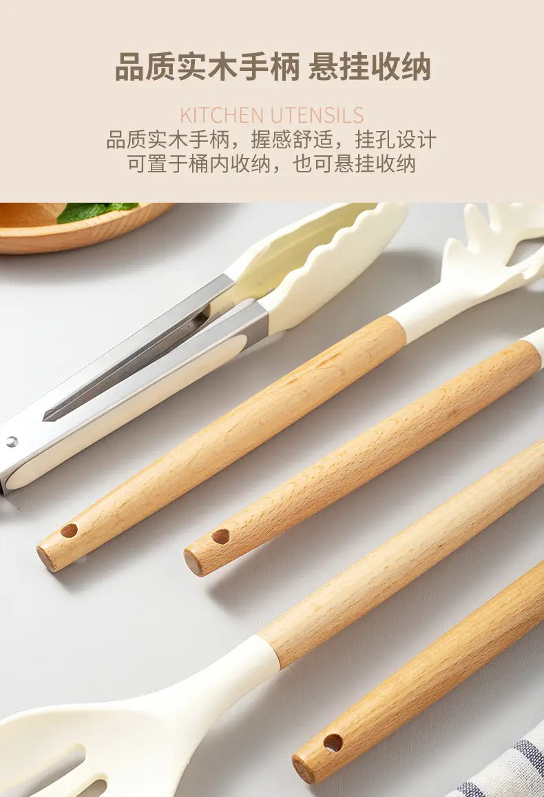Set of white silicone kitchen utensils with natural wood handles featuring a sleek design for modern kitchens.