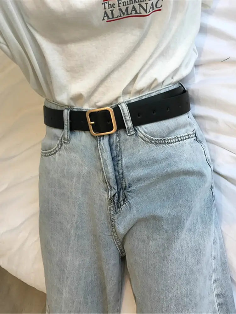 Black leather women belt featuring a gold toned square buckle suitable for casual fashion waist strap use.