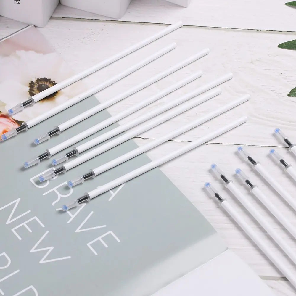 white gel ink refills with transparent caps and black nibs neatly arranged on a light-colored surface for gel pen refills black ink 10 pack 13cm