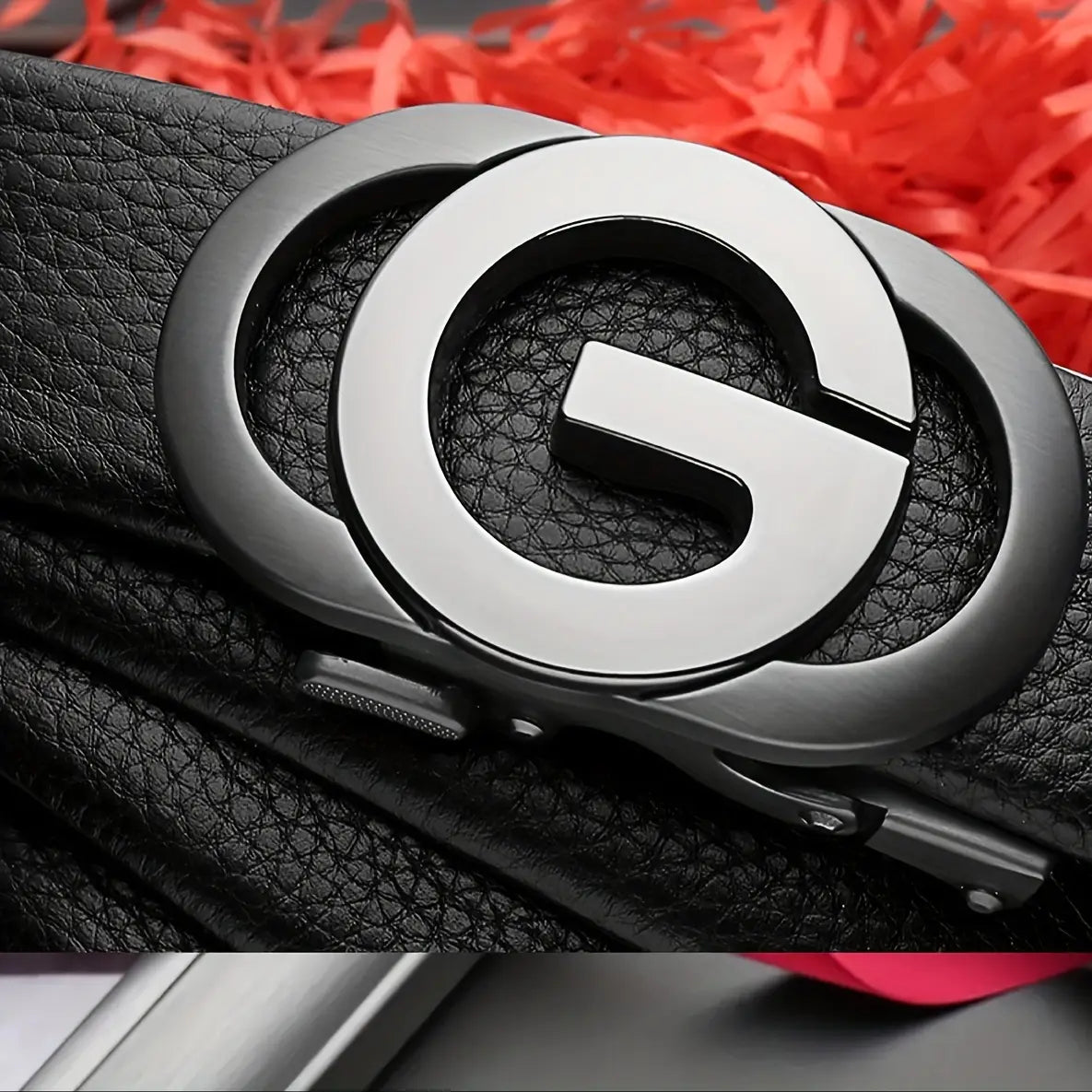 Mens automatic buckle leather belt in black featuring a sleek metallic silver buckle with an interlocking g design.