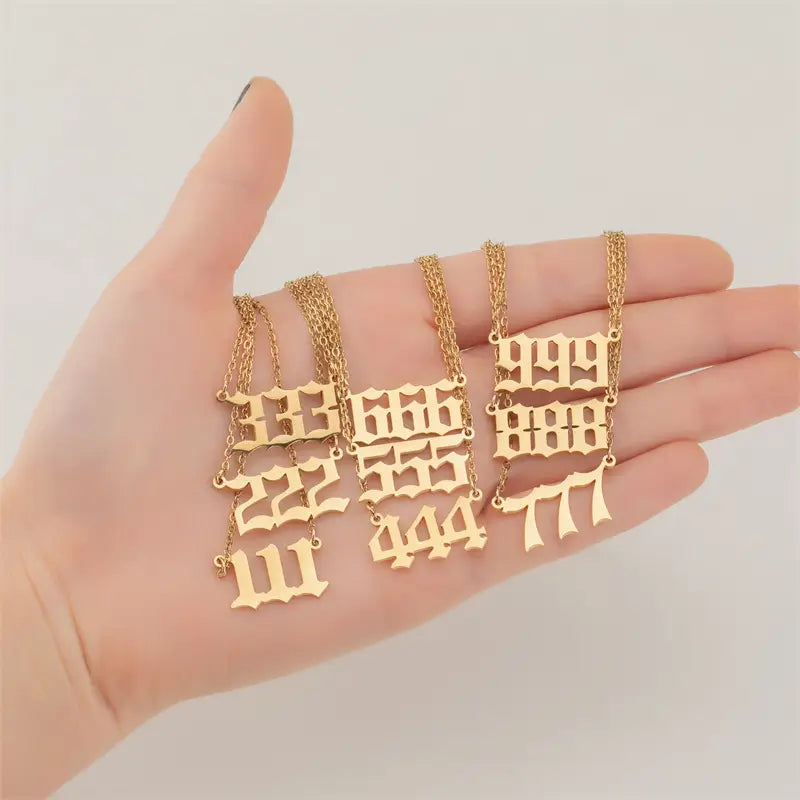 Gold-colored gothic-style number seven pendants on delicate chains designed as angel number necklaces.
