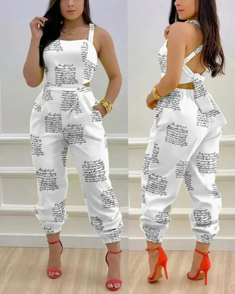 women summer printed cutout jumpsuit in white with black handwritten script pattern and a gold-toned belt.