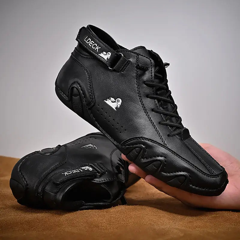 Men high top leather casual sneakers in black featuring a sleek modern design with subtle white branding on the side and heel.