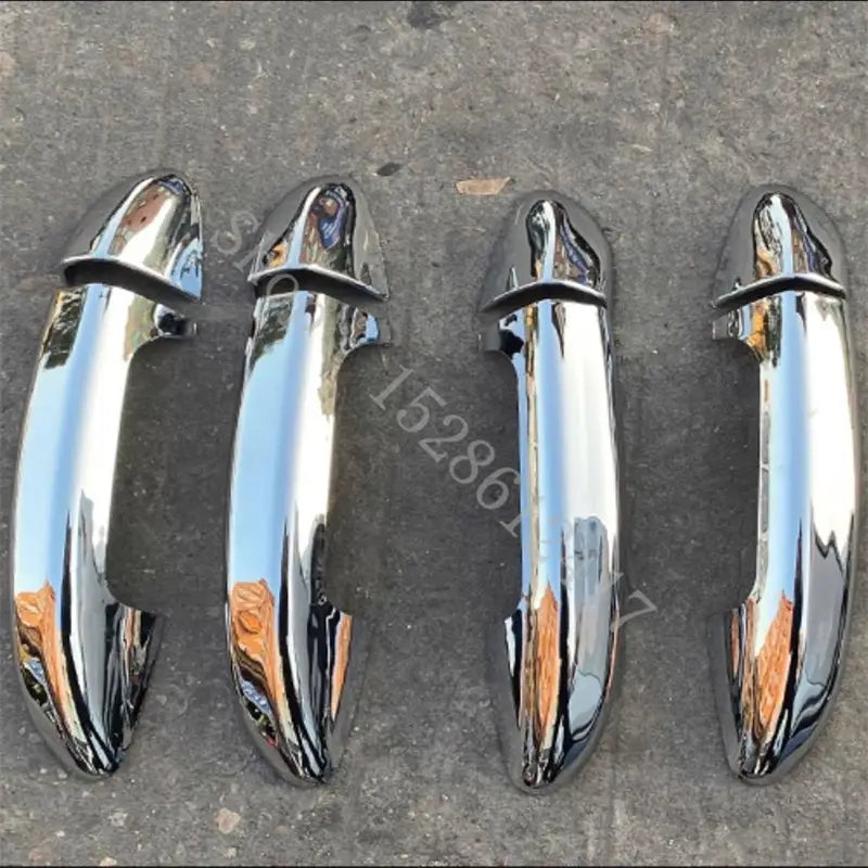 Four sleek chrome-finished vw passat door handle cover trims with a glossy reflective surface and smooth curved design in carbon fiber material.