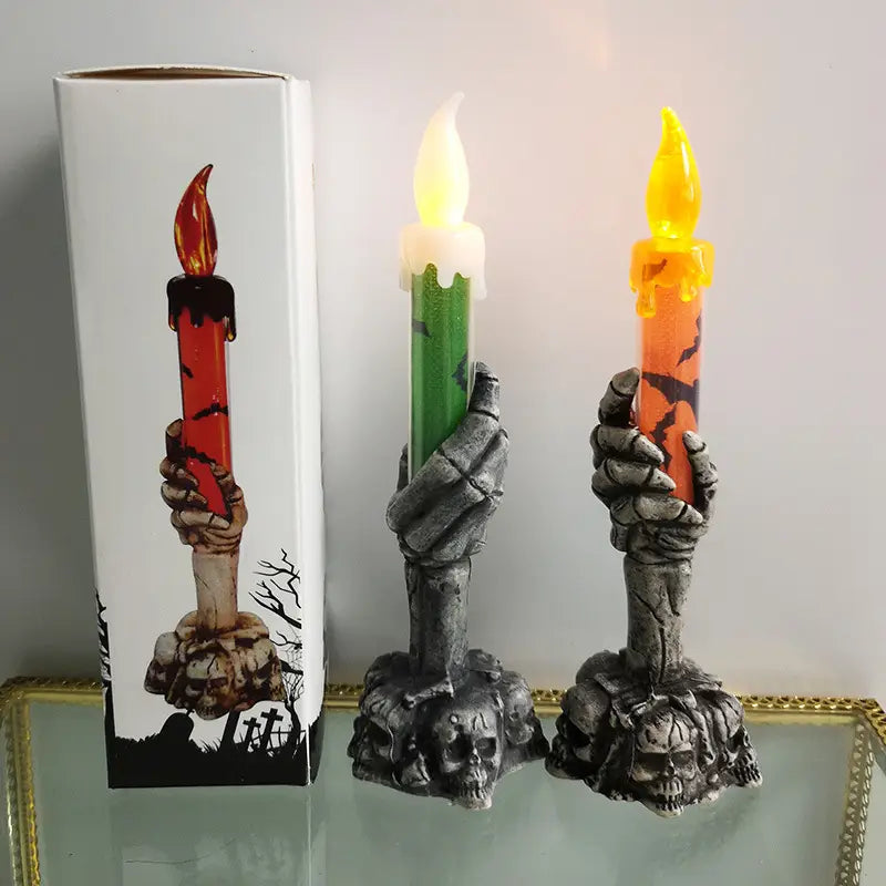 gray skeleton hand led candle holders featuring glowing orange and green candles for party happy halloween decorations