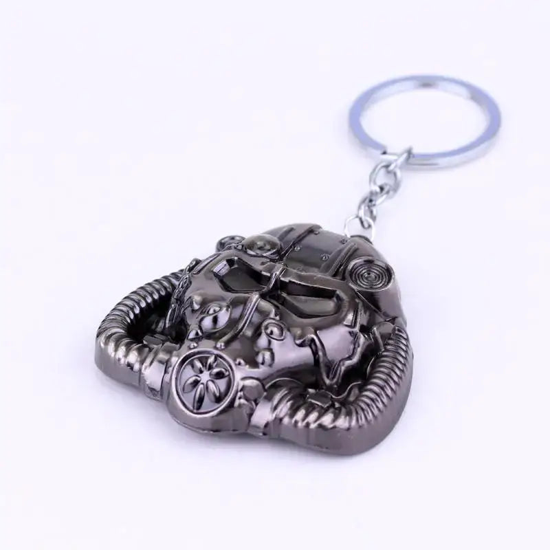 dark gray metallic Fallout power armor helmet keychain featuring a detailed textured gas mask design with visible hoses and circular vents