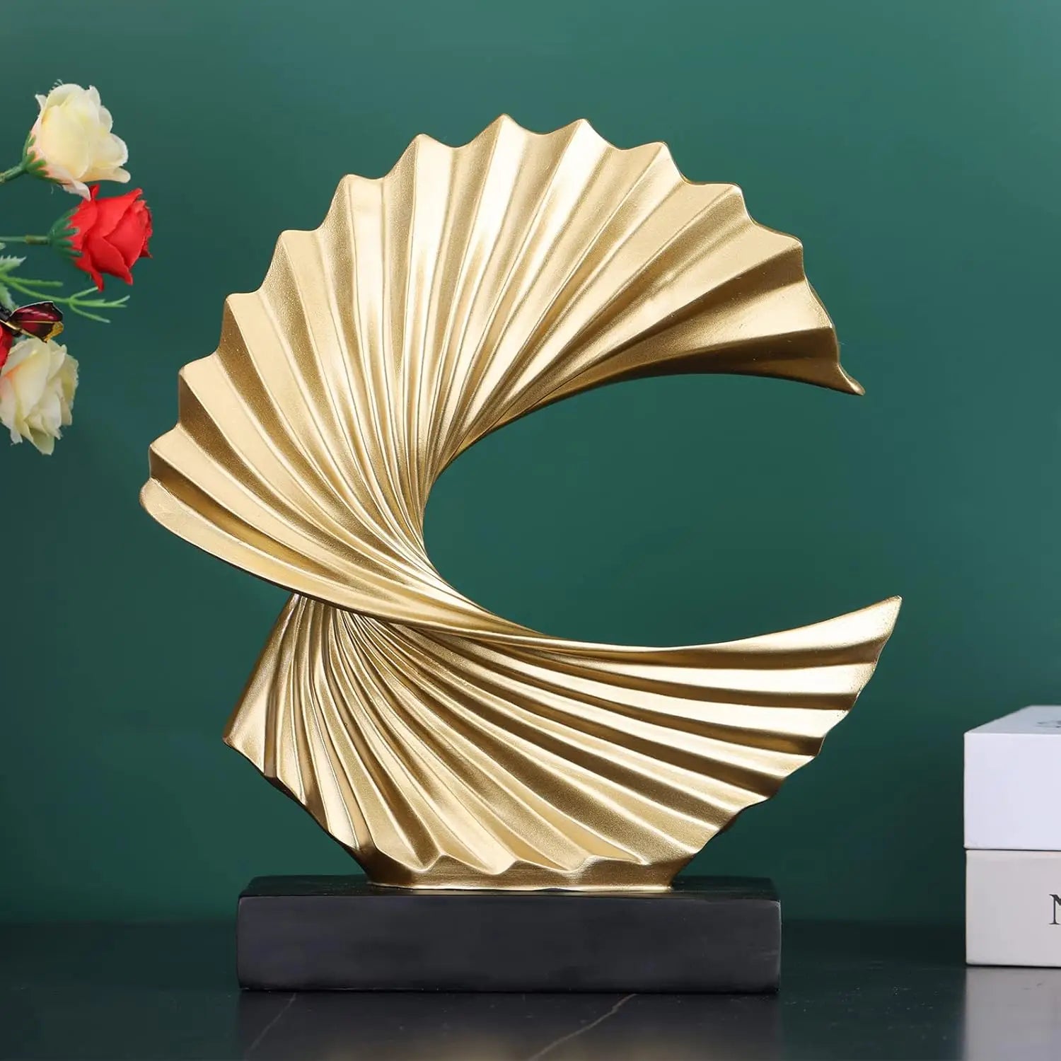 art deco gold wave sculpture tabletop decor featuring a glossy finish with layered ridges on a sculpted shell shaped decorative object