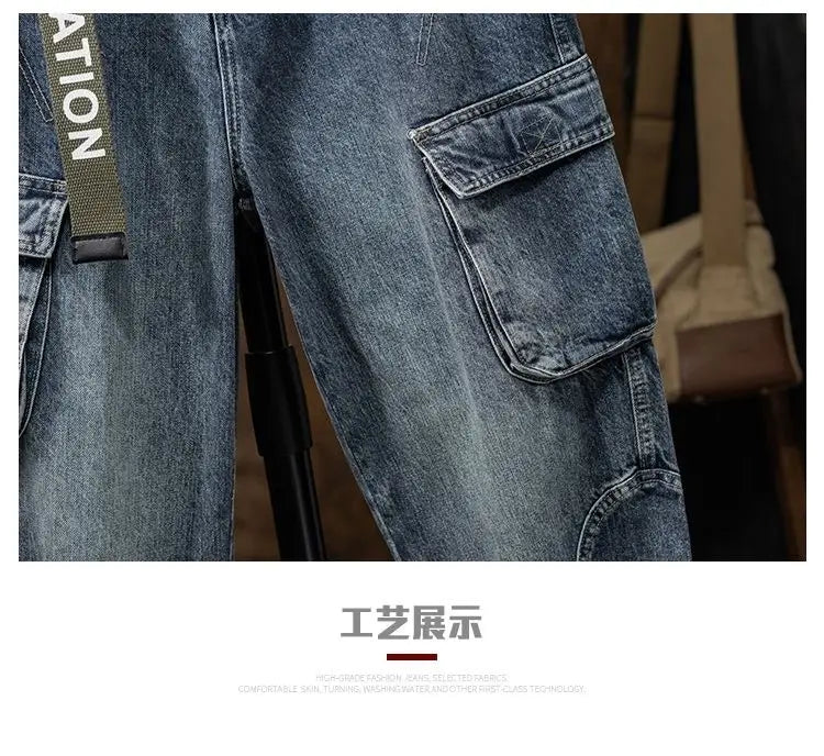 Men denim cargo jeans casual loose pants in blue denim featuring multiple pockets and a green belt strap with white lettering.