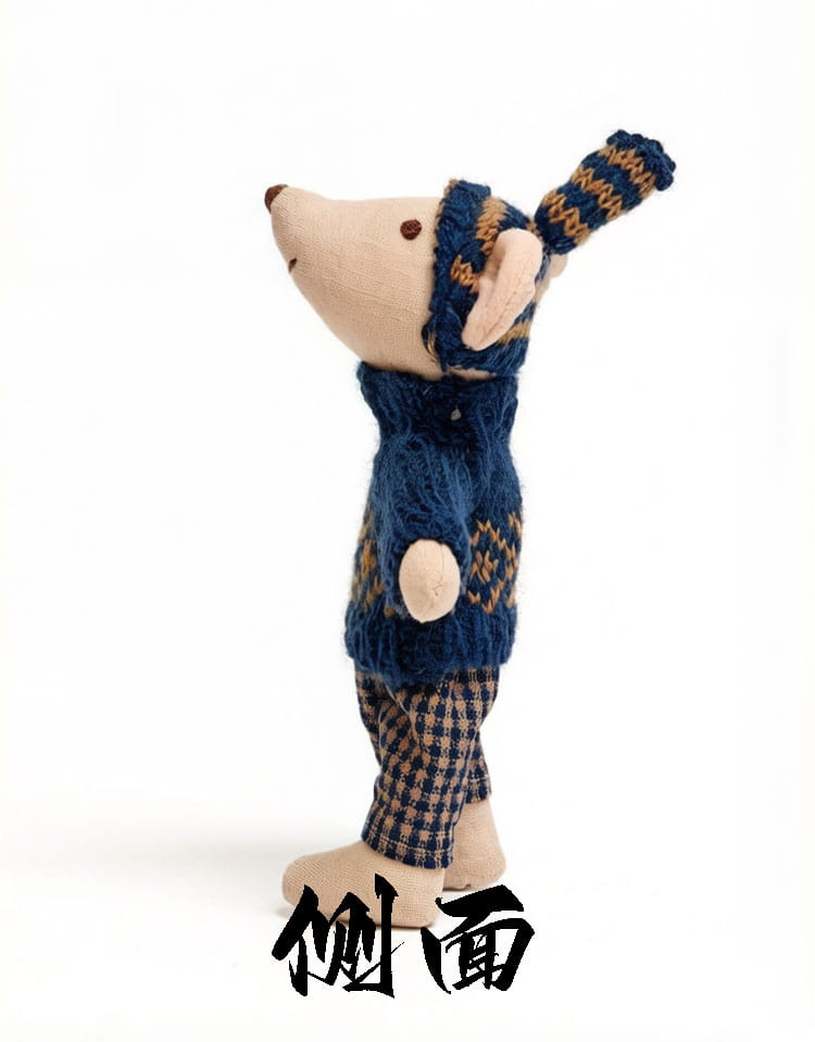 A charming beige mouse plush toy dressed in a navy blue and tan knitted sweater, scarf, and hat with matching plaid pants.