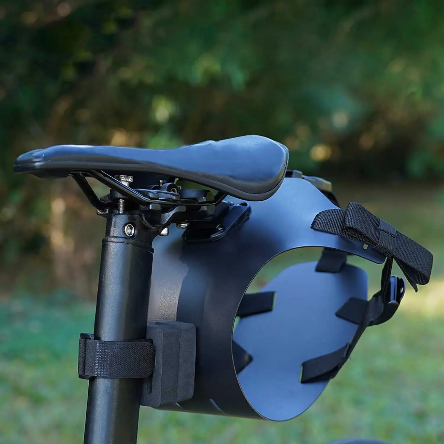Black matte-finish bike saddle bag stabilizer bracket carrier with adjustable straps and sleek curved design shown from the back side.