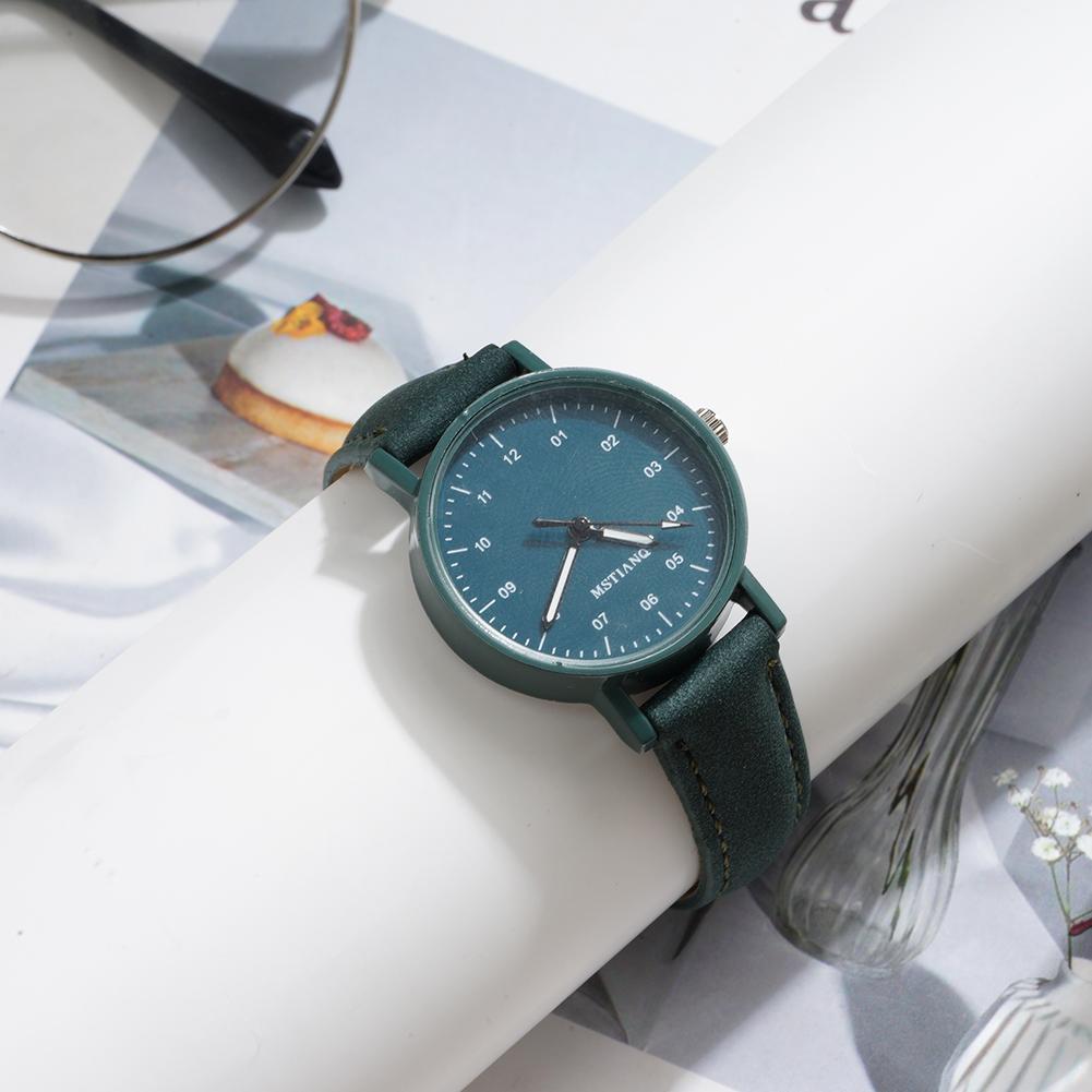 A sleek women quartz watch with a green pu leather strap and a dark teal dial featuring minimalist black hour markers, designed as a waterproof wristwatch.