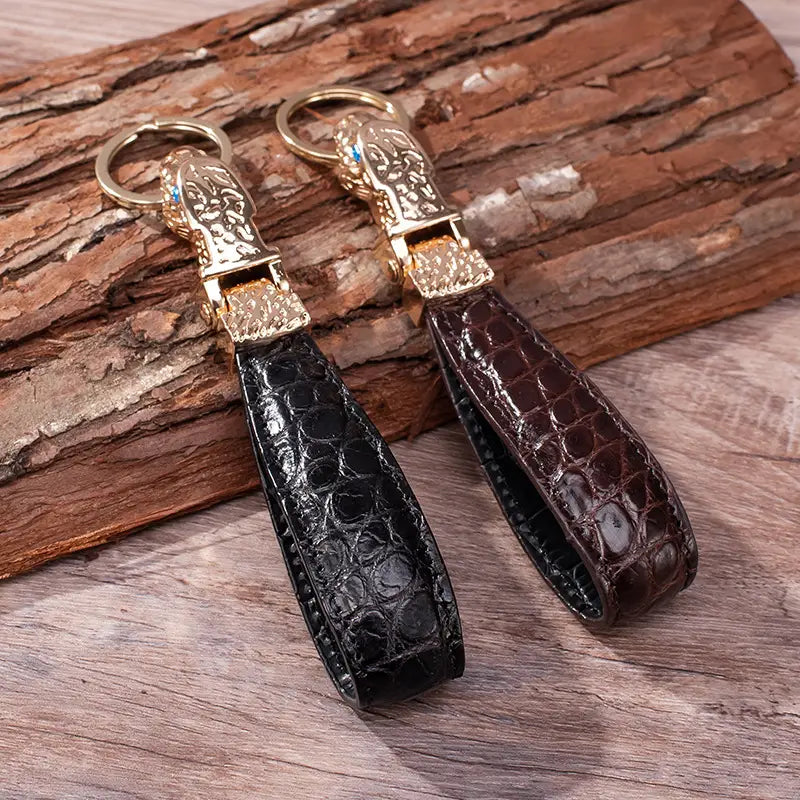 Elegant black and brown crocodile-embossed leather leather tiger head keychain with gold-toned metal clasp featuring intricate engraved designs for luxury car key rings.