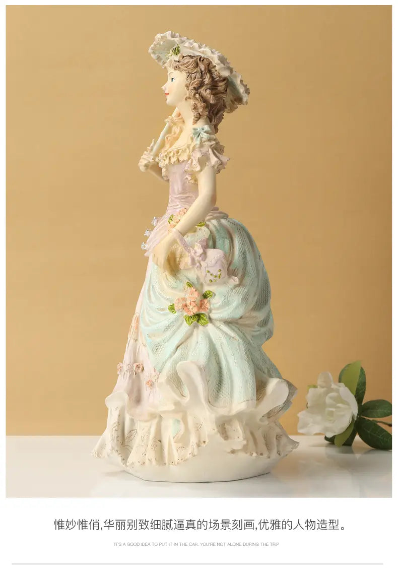 A delicate porcelain figurine of a woman in an elegant ruffled gown with pastel pink and mint green hues featured in the Victorian couple resin figurine home decor.