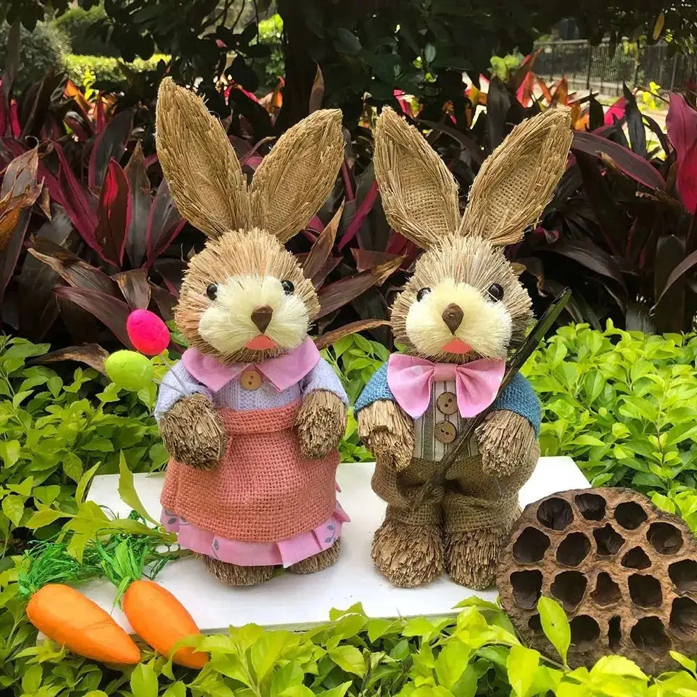 Two handcrafted 35cm straw Easter rabbit figurines set featuring one bunny in a pink apron and another in a blue vest with a bow tie.