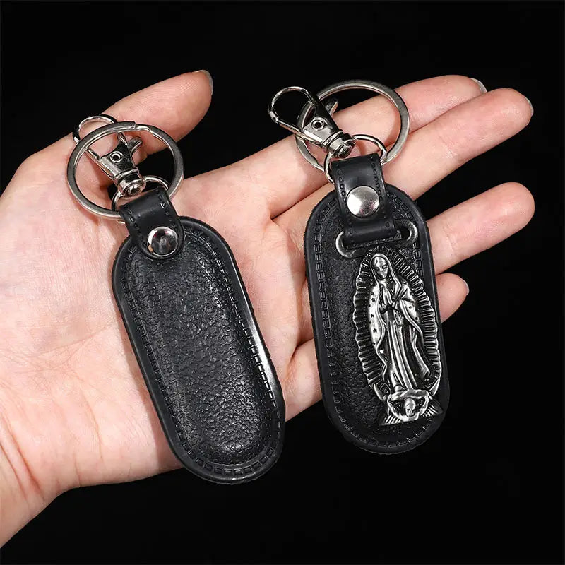 black leather saint christopher keychain with silver-toned metal clasp and detailed relief of the virgin of guadalupe in antique bronze finish