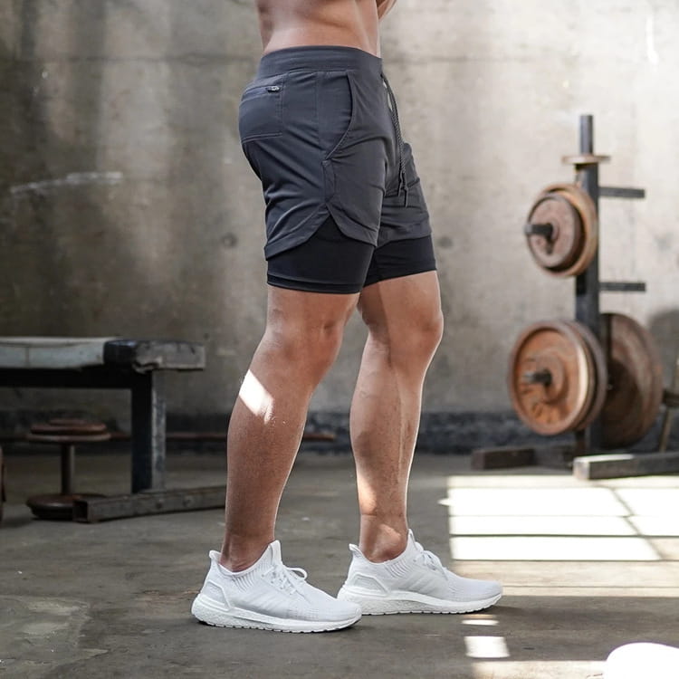 Men 2 in 1 gym shorts in dark gray featuring a two-layered quick dry design with multiple pockets for workout and activewear use