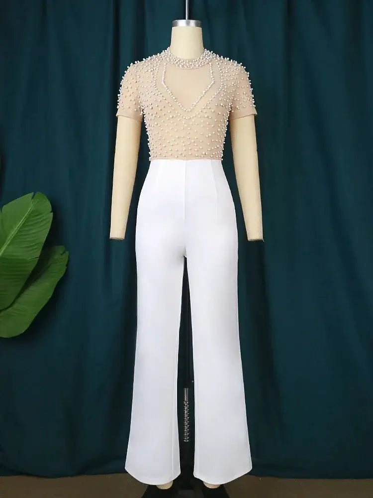 beige beaded mesh top paired with white high-waisted flared pants as an elegant party jumpsuit outfit