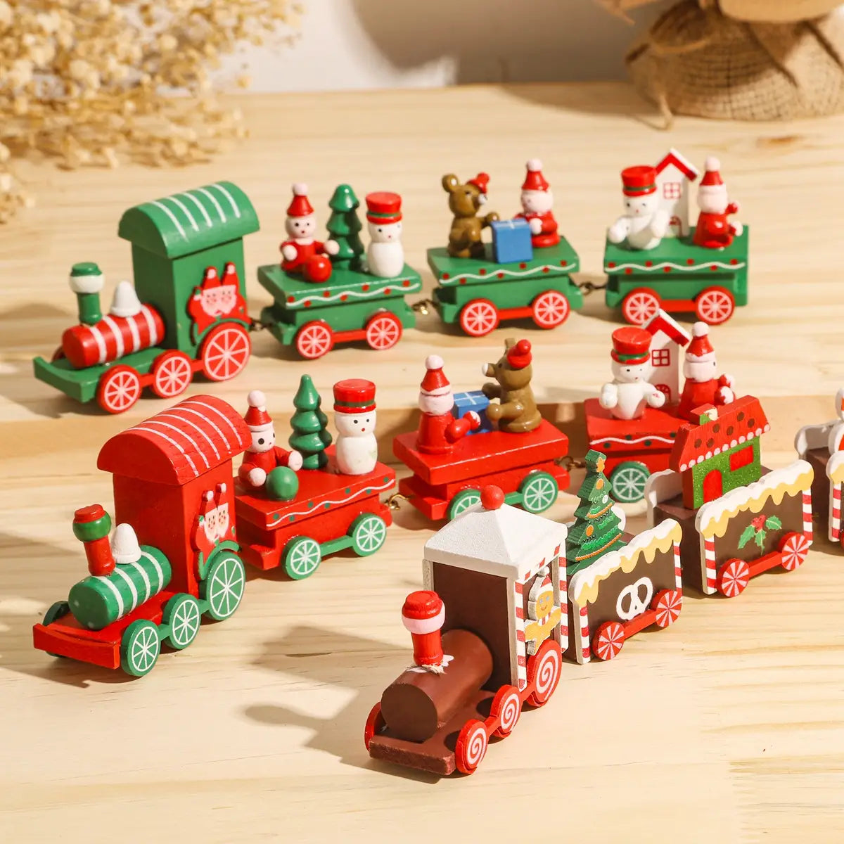 Wooden Christmas train toy holiday home decoration featuring a red and green wooden train set with miniature snowmen, reindeer, and festive carriages.