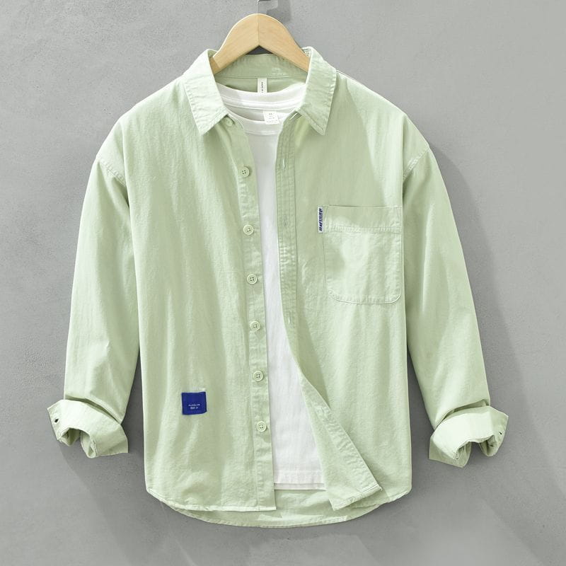 Camisa de vestir casual para hombre de un solo color, verde claro, de manga larga, con bolsillo en el pecho y puños arremangados.