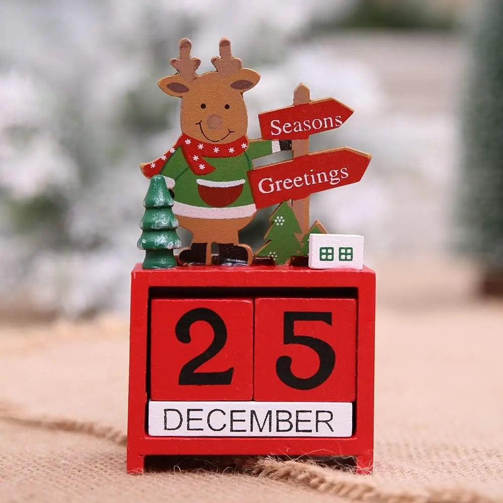 Red wooden Christmas countdown calendar blocks featuring a festive reindeer figurine in a green sweater and red scarf standing atop alongside miniature trees and signs.