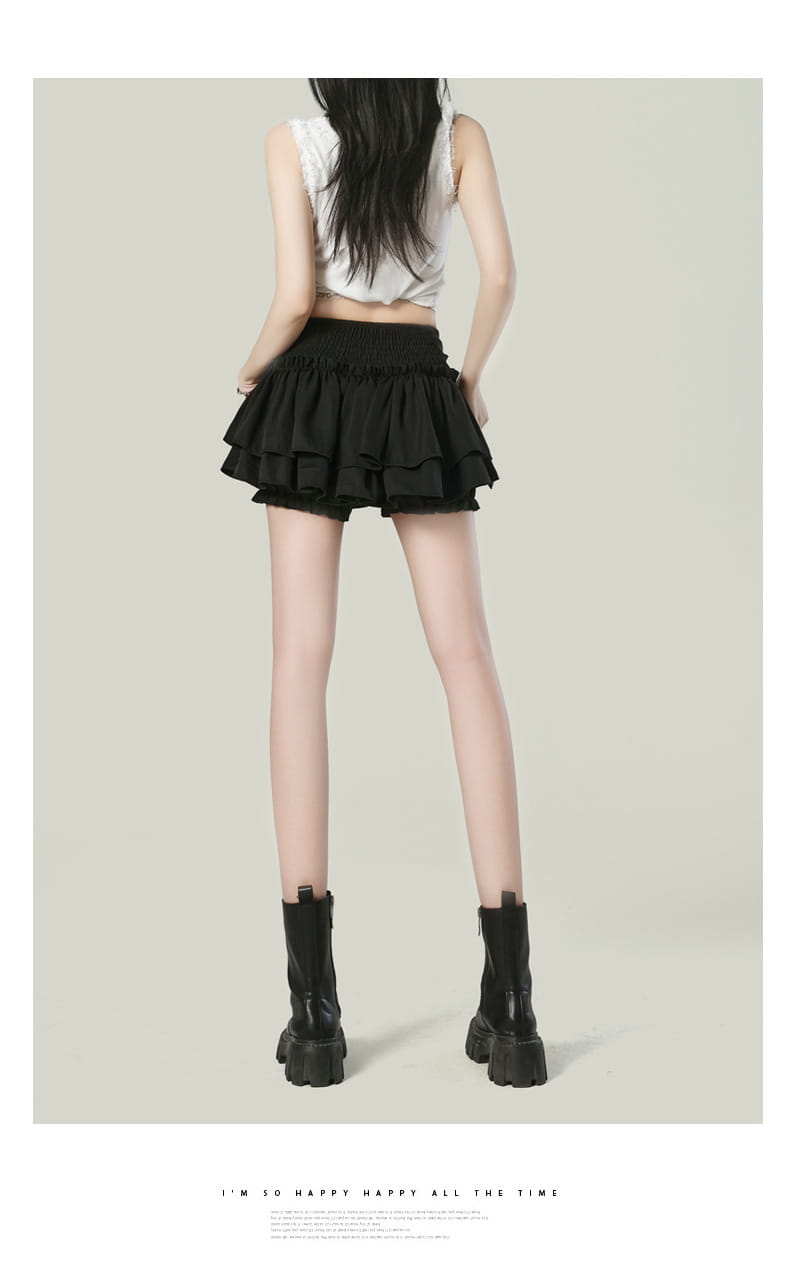 Black ruffled high waist mini skirt with elastic waistband designed in a Y2k style.
