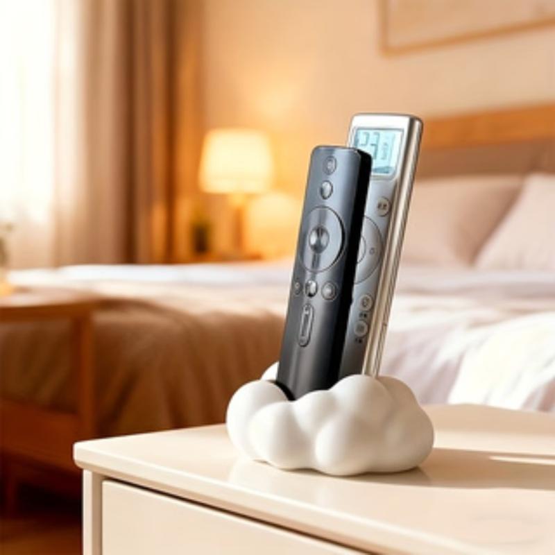 White ceramic cloud-shaped remote control holder standing on a desktop and holding two remotes for organized living rooms.