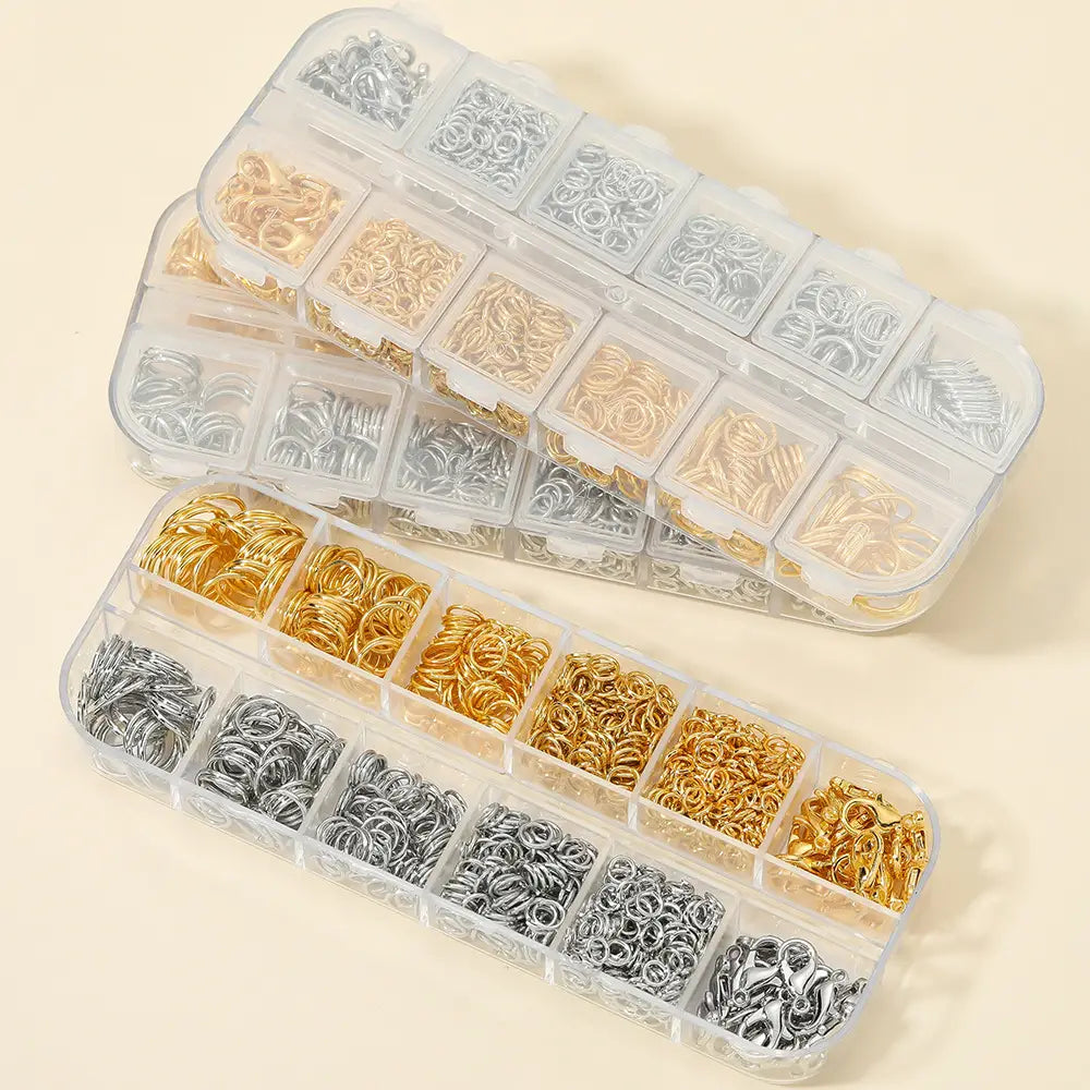 clear plastic organizer box with compartments filled with assorted gold and silver-colored metal jump rings for diy jewelry making findings kit with tools