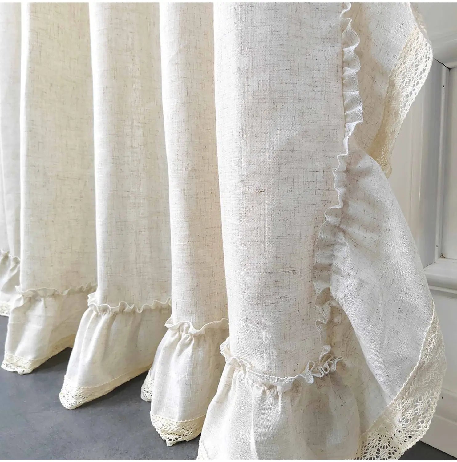 Cream-colored linen curtains with delicate lace trim and ruffled edges in two pieces for living room use with accept customization options.