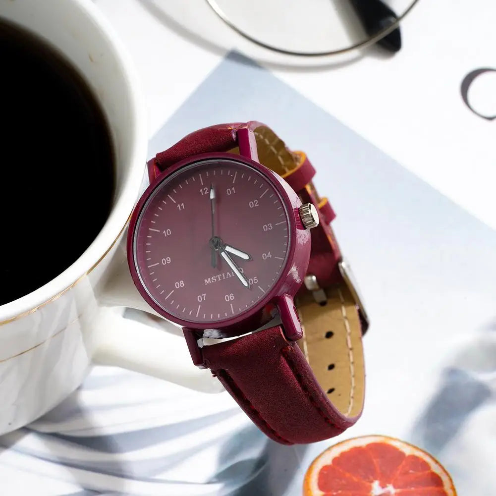 A women quartz watch with a burgundy pu leather strap and matching dial featuring silver-tone hands and the brand name mstian.