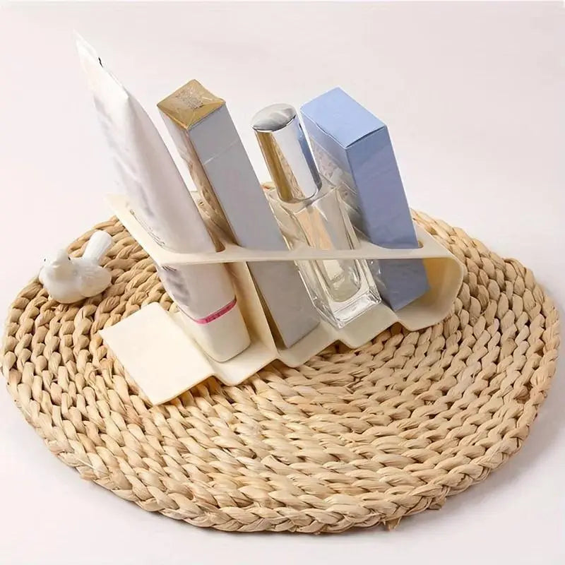 Beige plastic remote control organizer desktop storage rack holding various toiletries for bathroom use.