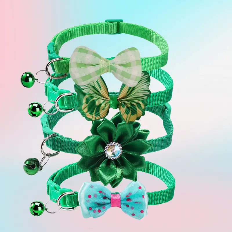 Set of four adjustable bow cat collars with bell in green featuring unique decorative bows in green and white checkered, gold-patterned, satin green flower with crystal center, and light blue polka-dotted designs with matching green bells attached.