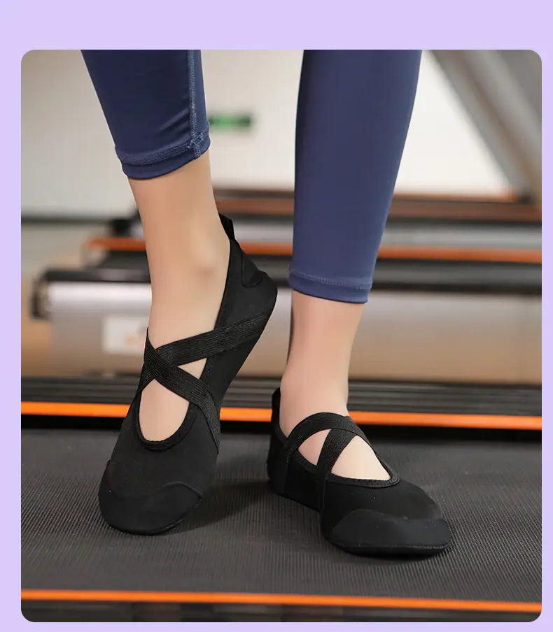 Black cross-strap women yoga shoes with a soft flexible upper and reinforced toe cap designed for anti-slip fitness flats.