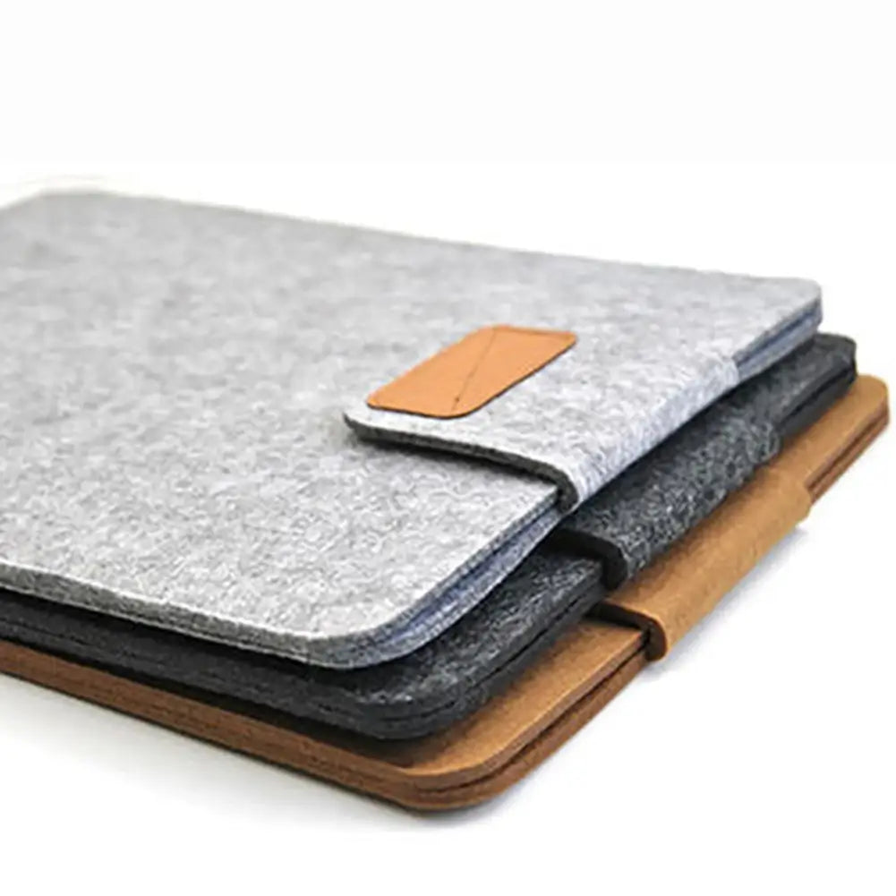 gray felt laptop bag sleeve with tan leather flap closure designed for macbook air and tablet bag use