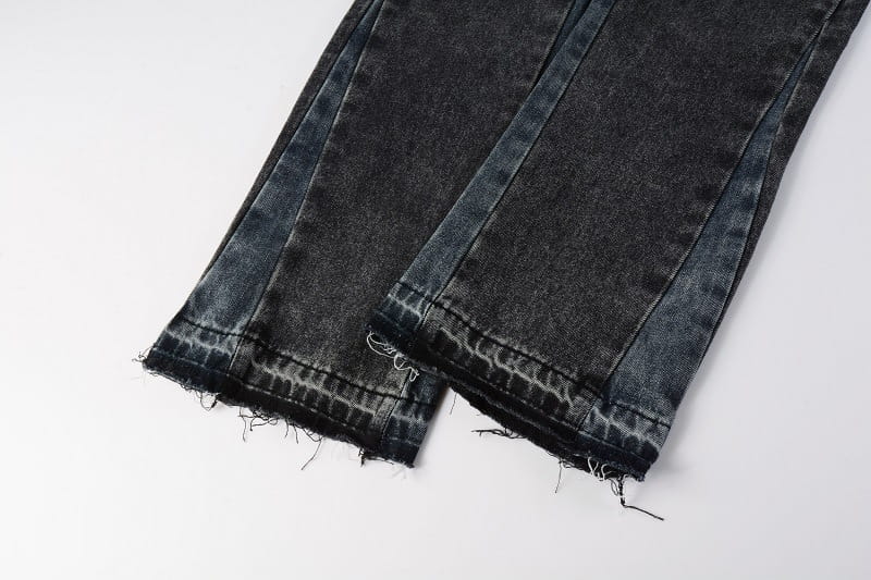 Men flare jeans in distressed dark gray denim with visible stitching and frayed hems
