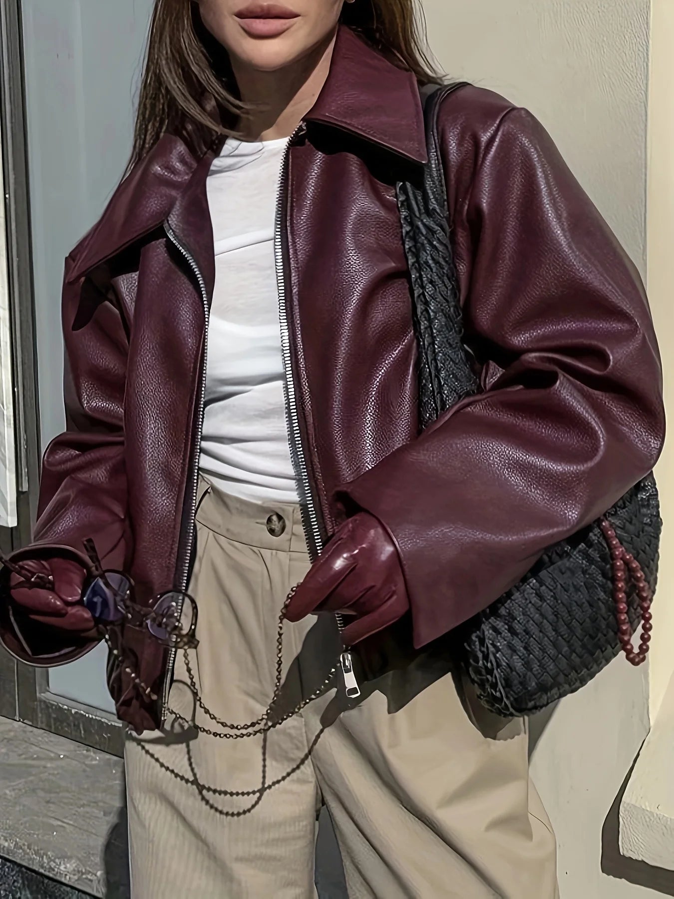 Burgundy faux leather bomber jacket with classic collar and front zipper for stylish outerwear.