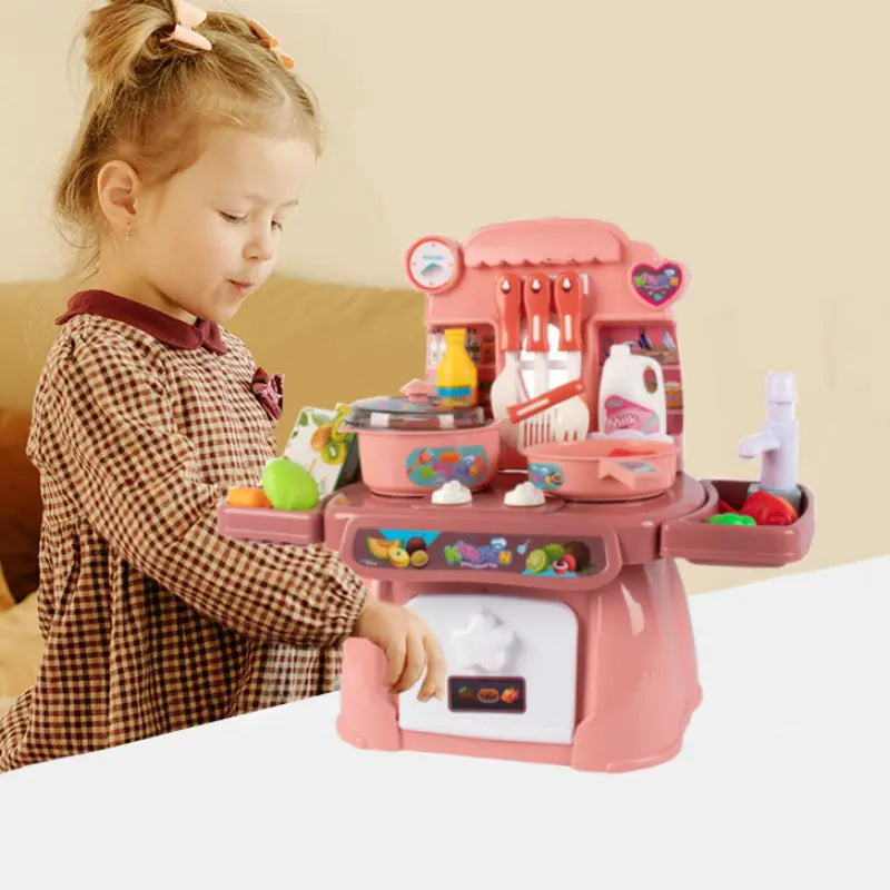 Rosa Kunststoff-Spielzeug-Küchen-Spielset mit Licht- und Soundeffekten, farbenfrohen Accessoires und herzförmiger Detailausführung an der Seite für fantasievolles Spiel.