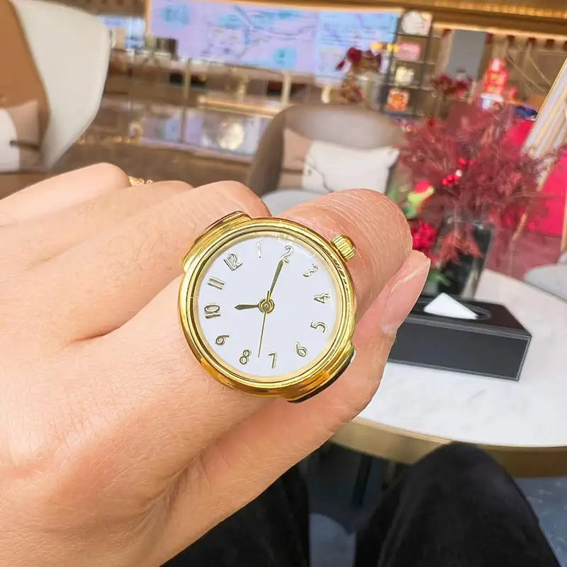 Gold-toned ring watch with a white dial and black arabic numerals designed as unisex quartz finger jewelry and gift.