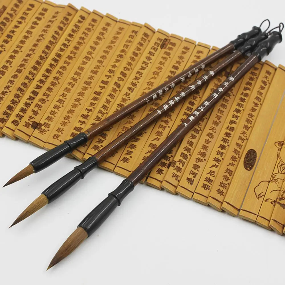Three traditional Chinese calligraphy brushes with dark brown handles black ferrules and natural bristles in a Chinese calligraphy brush set 6 piece writing practice.