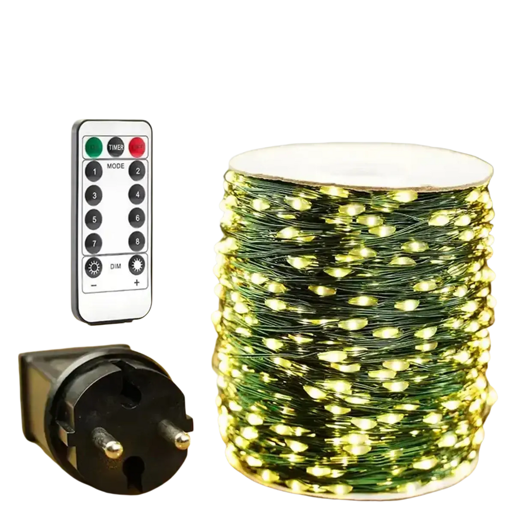 A spool of warm white led string lights with green copper wire next to a remote control and power plug for outdoor use