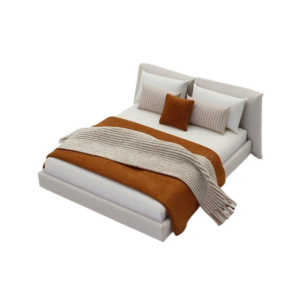 Miniature dollhouse double bed with modern white upholstered frame and layered bedding in warm terracotta and neutral tones cream style.