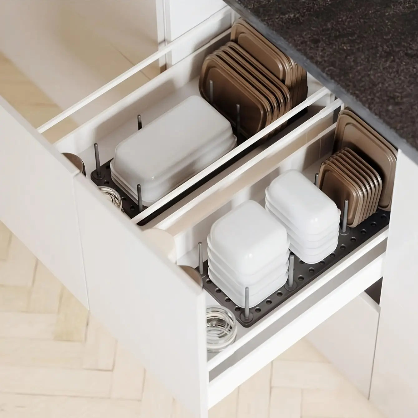 adjustable kitchen drawer pegboard organizer displaying white and bronze baking trays neatly organized in a modern kitchen drawer.