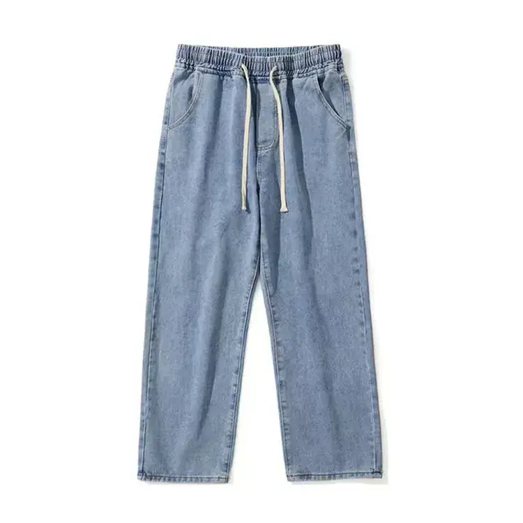 Pantalon de survêtement en denim délavé clair avec coupe décontractée et cordons blancs, issu de la collection de jeans en denim ample à jambes larges, à broderie croisée.