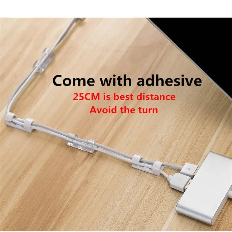 White plastic cable organizer clips with adhesive backing for desktop cord management and neat spacing of cords.