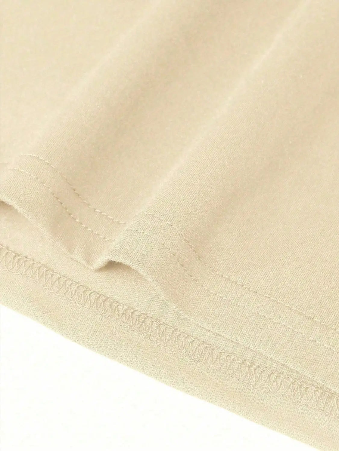 beige cotton fabric with neat stitched hem detailing on a graphic print oversized men short sleeve t shirt.