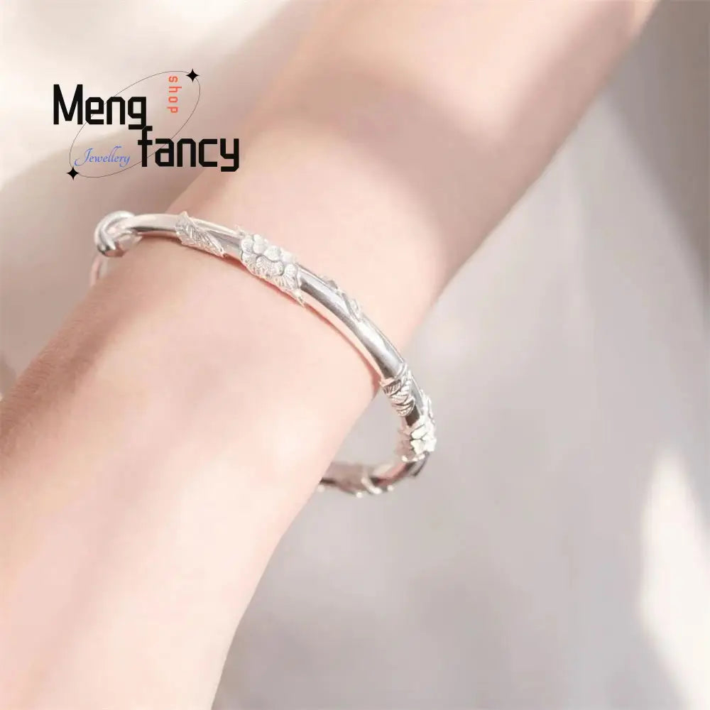 silver floral-patterned bangle bracelet with intricate engraved details paired with a natural jade raw stone in a floral sliding design