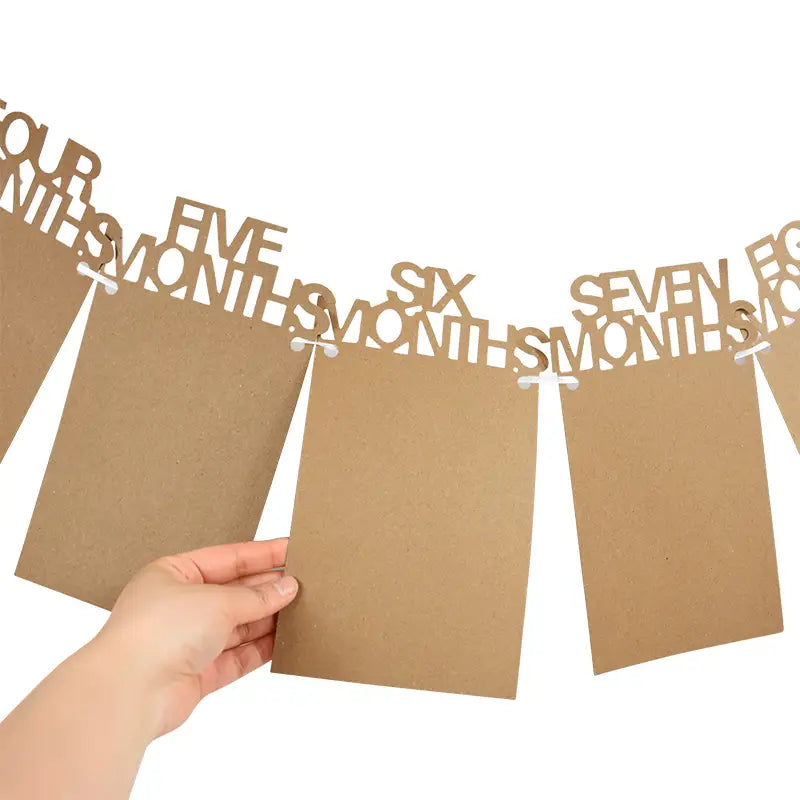 brown cardboard photo banner with cut-out numbers and months designed for 1st birthday photo monthly picture garland display.