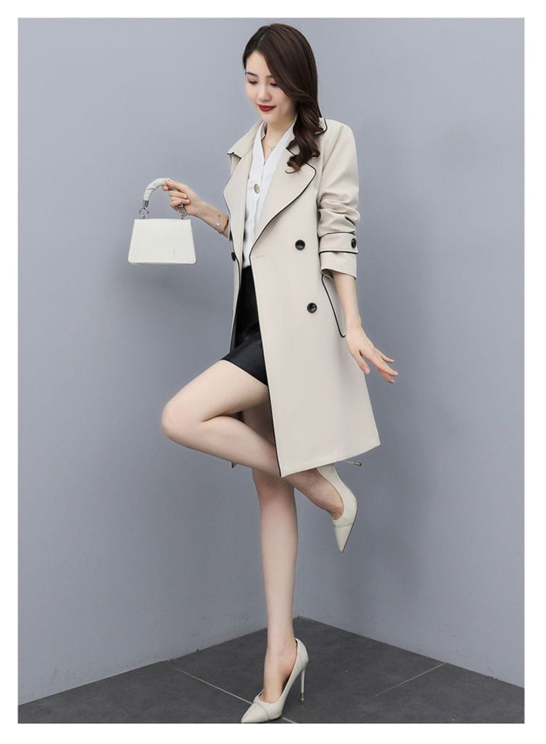 Beige women double breasted trench coat featuring black button accents and subtle trim in a classic design.